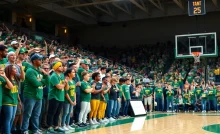 Northern Michigan Wildcats basketball team celebrating with fans