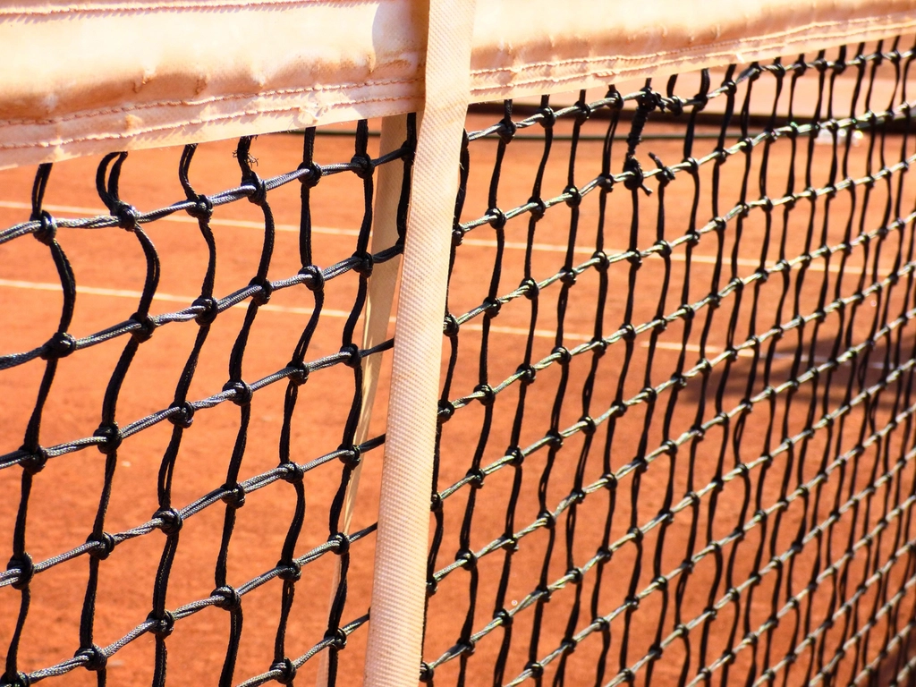 Tennis court with net and racket