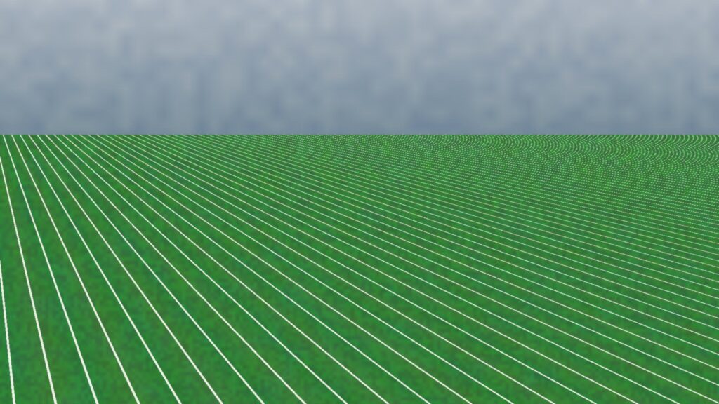 Empty green football field with white yard lines under a gray sky