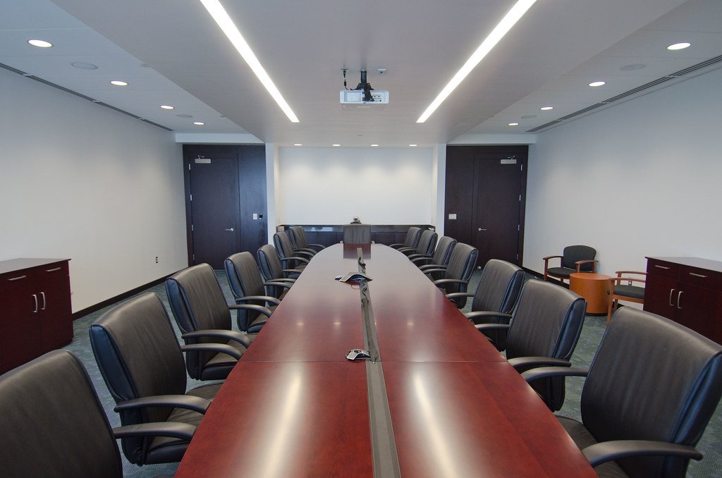 Empty meeting room with a long table and chairs